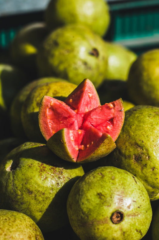 Fresh guava cut open showing pink flesh